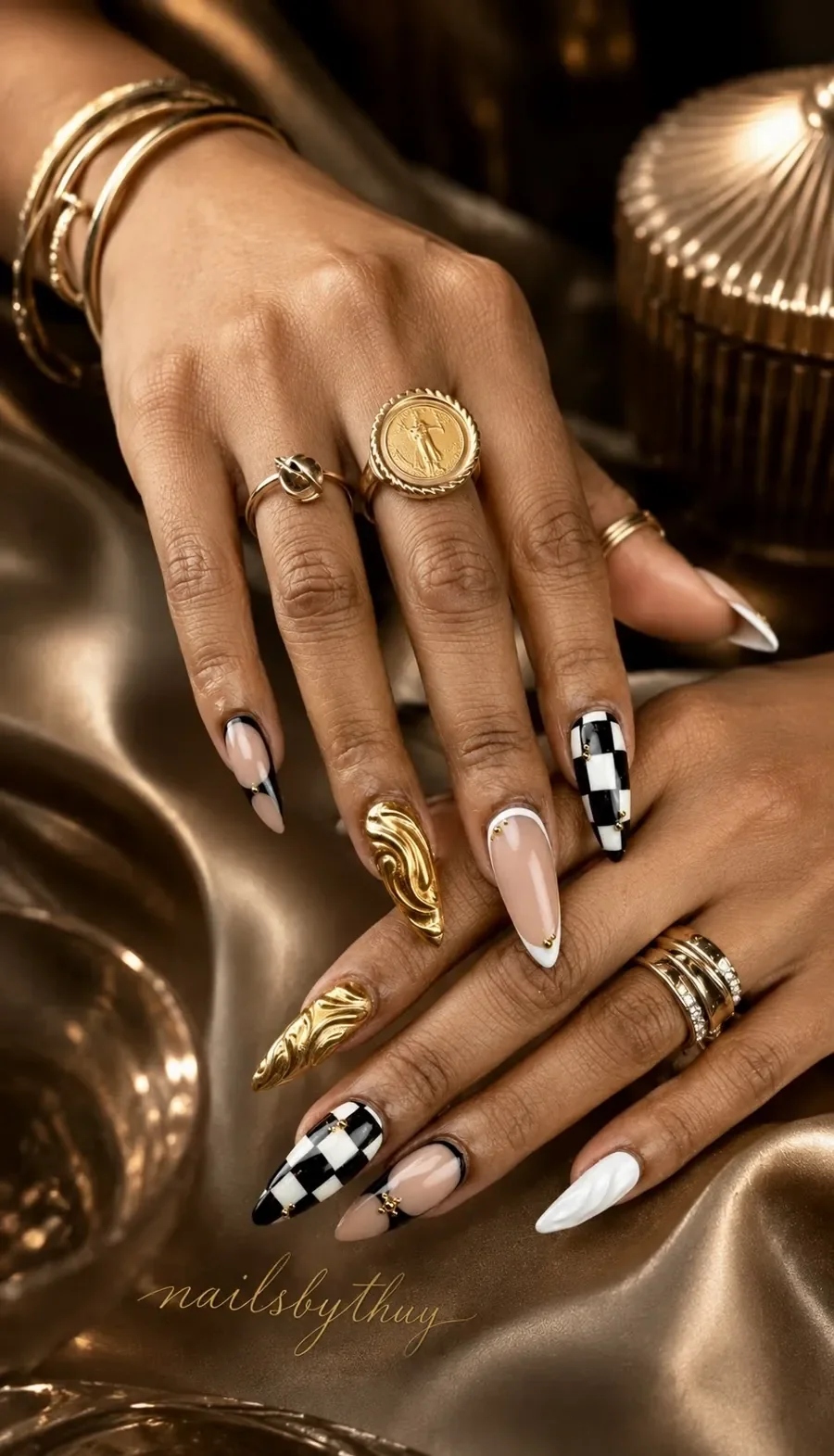 Chrome almond nails with checkerboard and gold swirl art — luxury nail studio Austin TX